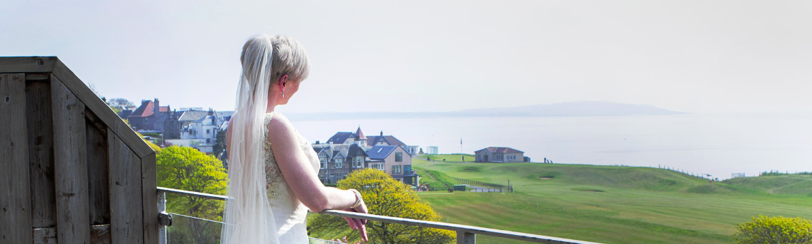 A bride admires the view from the Old Manor